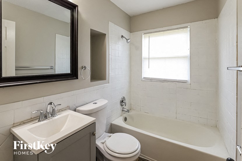 a bathroom with a sink toilet and a bath tub