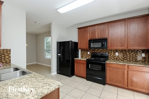 a kitchen with black appliances and granite counter tops