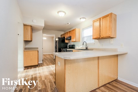 a kitchen with wooden cabinets and a counter top in a house