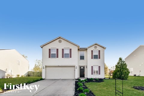 A two-story house with a garage is for sale.