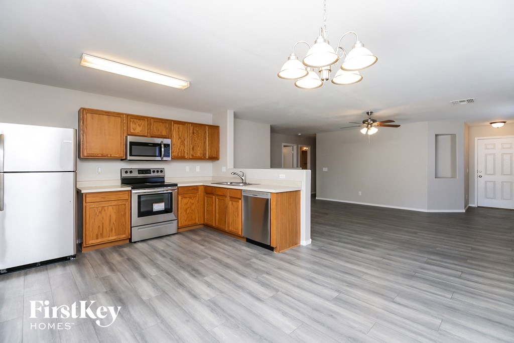 A kitchen with wooden cabinets and a white refrigerator.