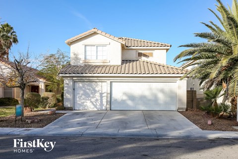 a house with a garage door in front of a driveway