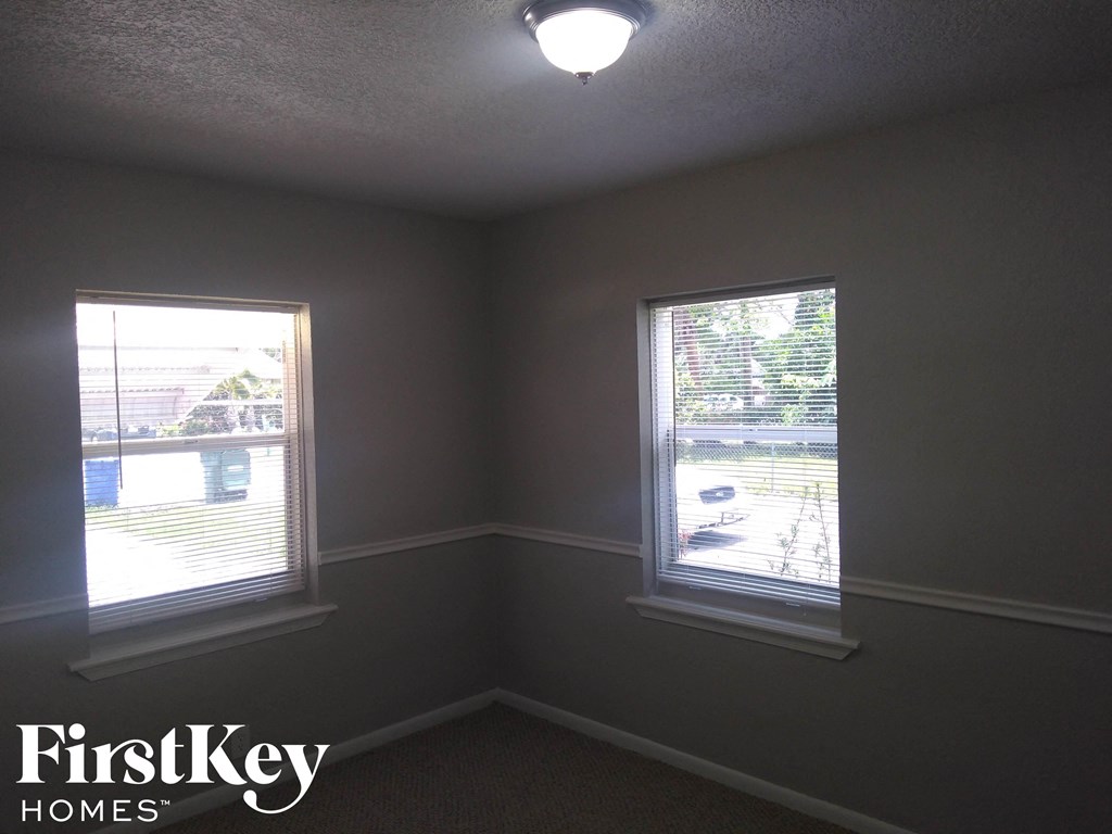 A room with two windows and a FirstKey Homes logo.