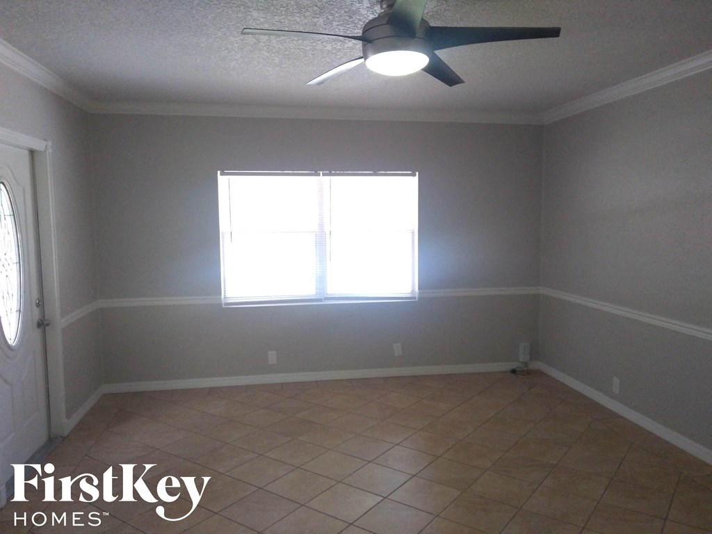 A room with a FirstKey Homes logo on the bottom left corner.