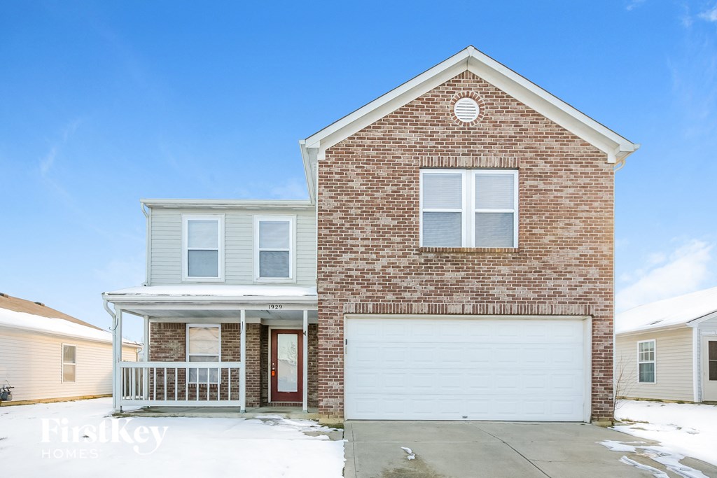 a brick house with a white garage door