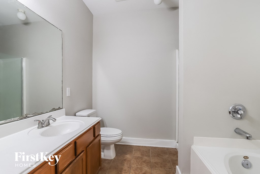 a bathroom with a toilet and a sink and a mirror
