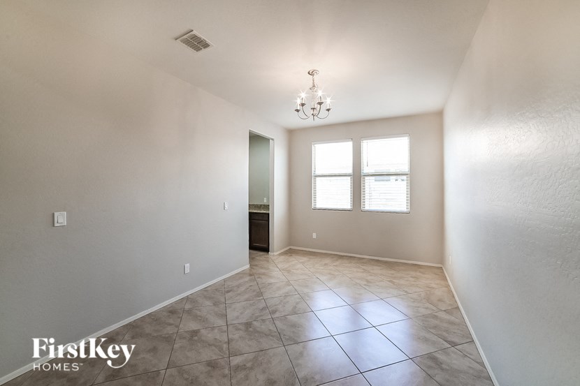 a empty living room with a window and tile floor