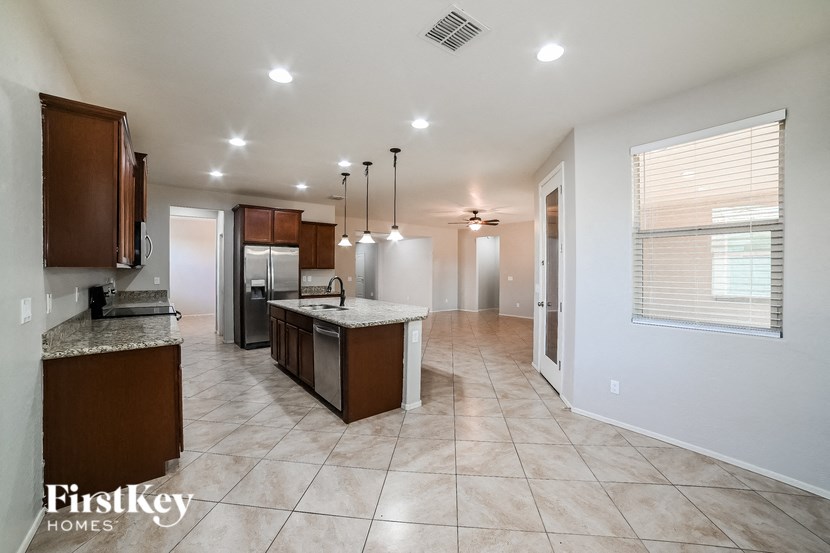 a kitchen and living room with a sink and a refrigerator