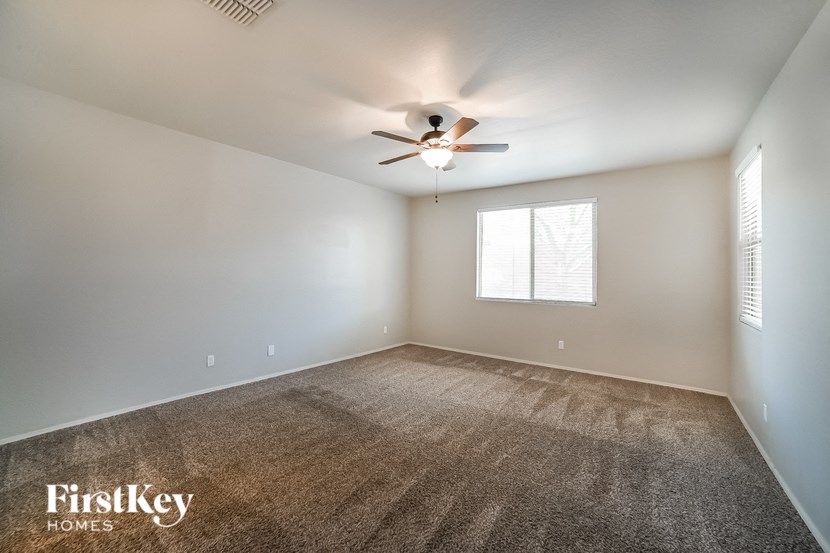 a living room with a ceiling fan and a window