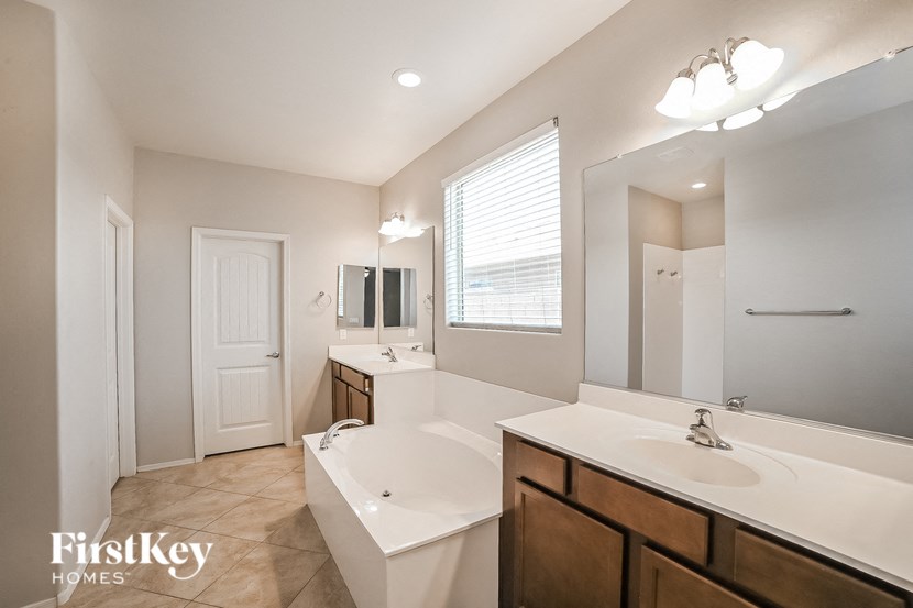 a bathroom with a tub sink and a mirror