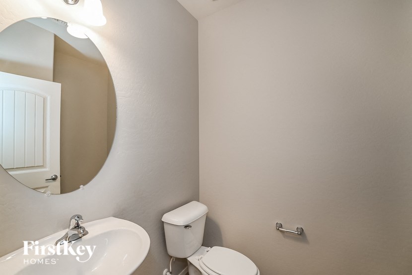 a bathroom with a toilet and a sink and a mirror