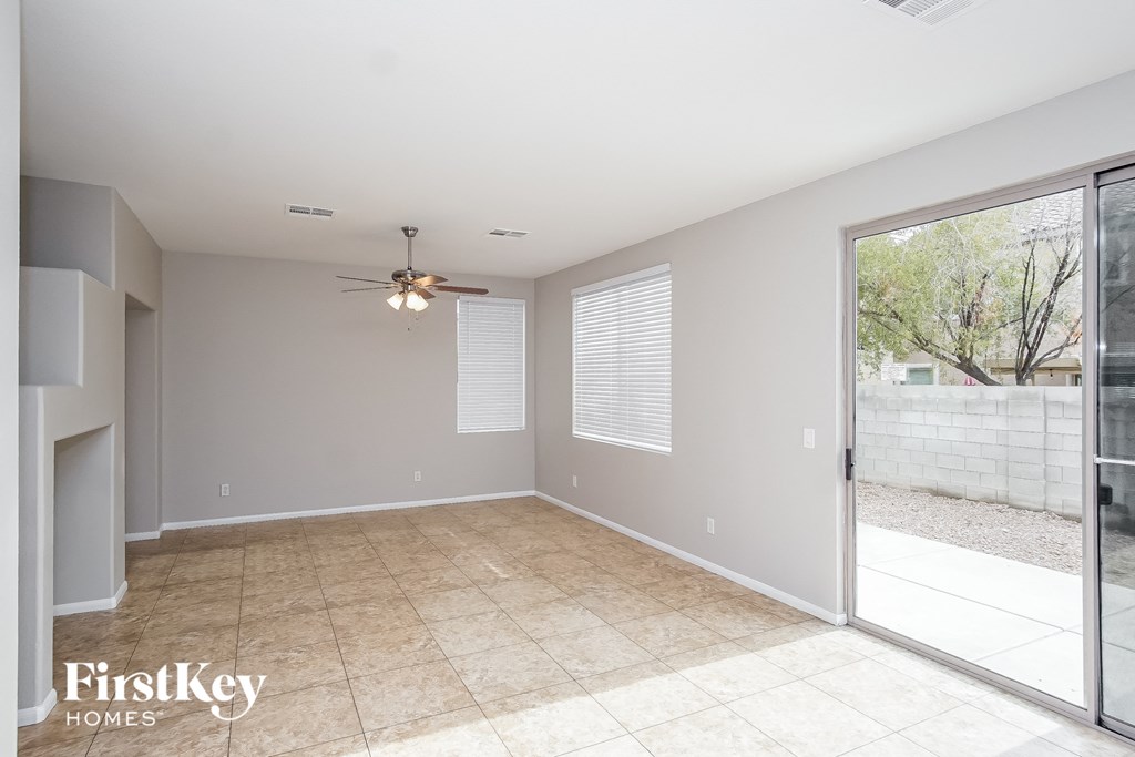 an empty living room with a sliding glass door to the patio