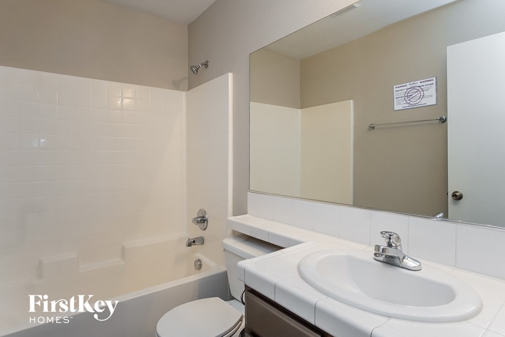 a bathroom with a sink and a toilet and a bath tub