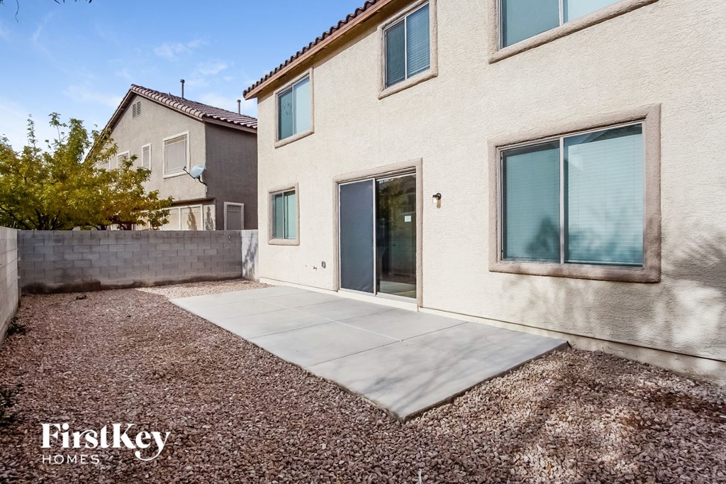 a side view of a house with a patio and a door