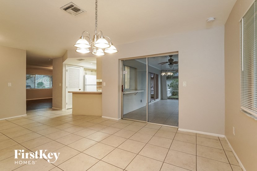 a kitchen and living room with a sliding glass door