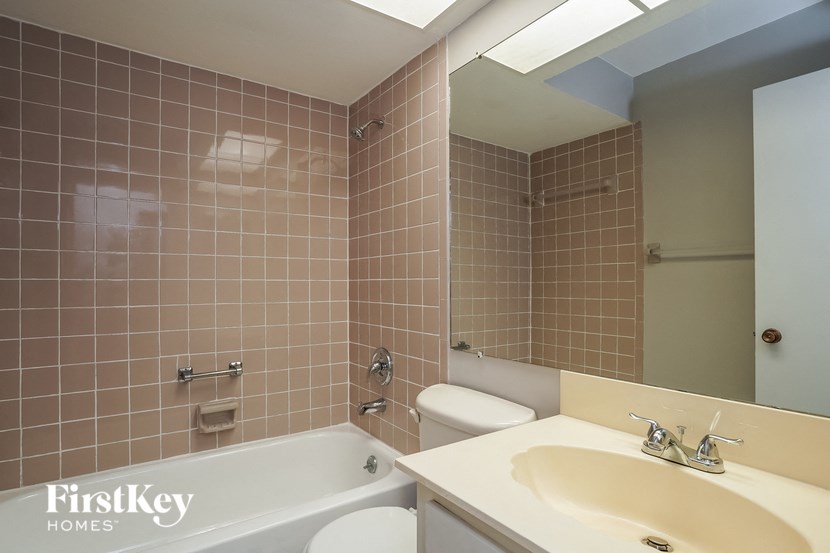 a bathroom with a sink toilet and a bath tub
