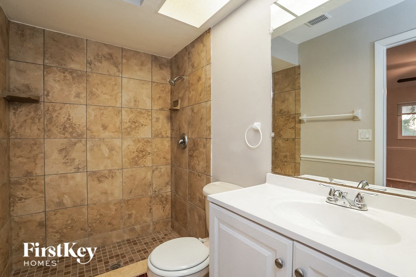 a bathroom with a sink toilet and a shower