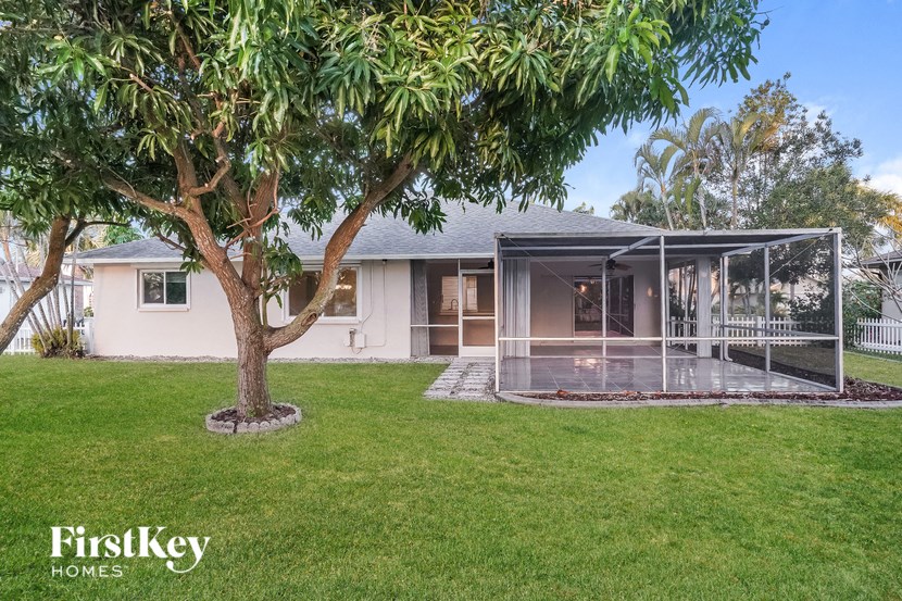 a house with a yard and a glass screened porch
