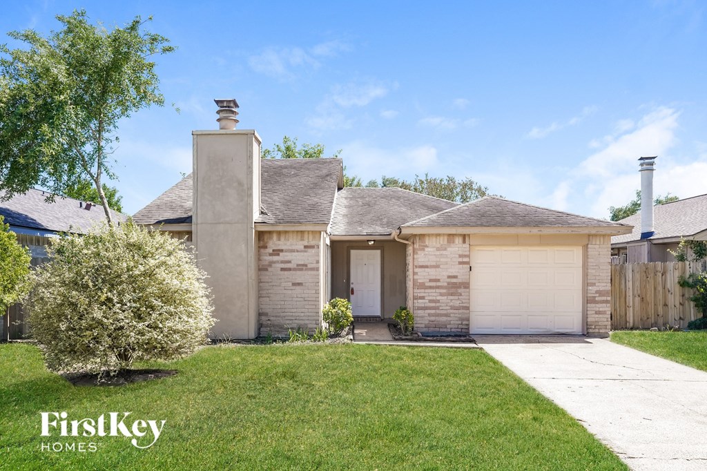 A house with a garage door is for sale by FirstKey Homes.