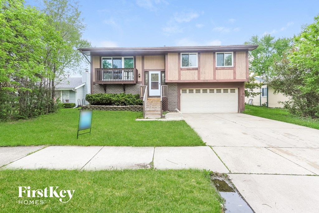 A two-story house with a garage is for sale.