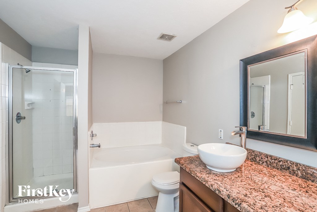 A bathroom with a sink, toilet, and bathtub.