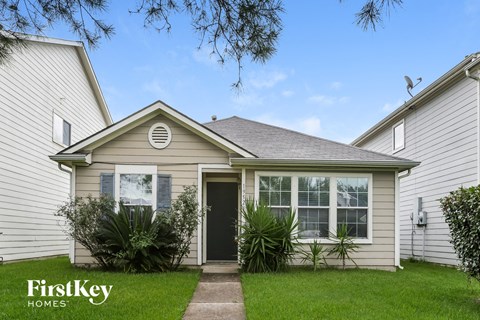 A house with a FirstKey Homes sign in front of it.