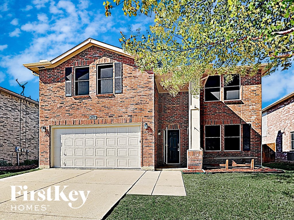 a large brick house with a white garage door