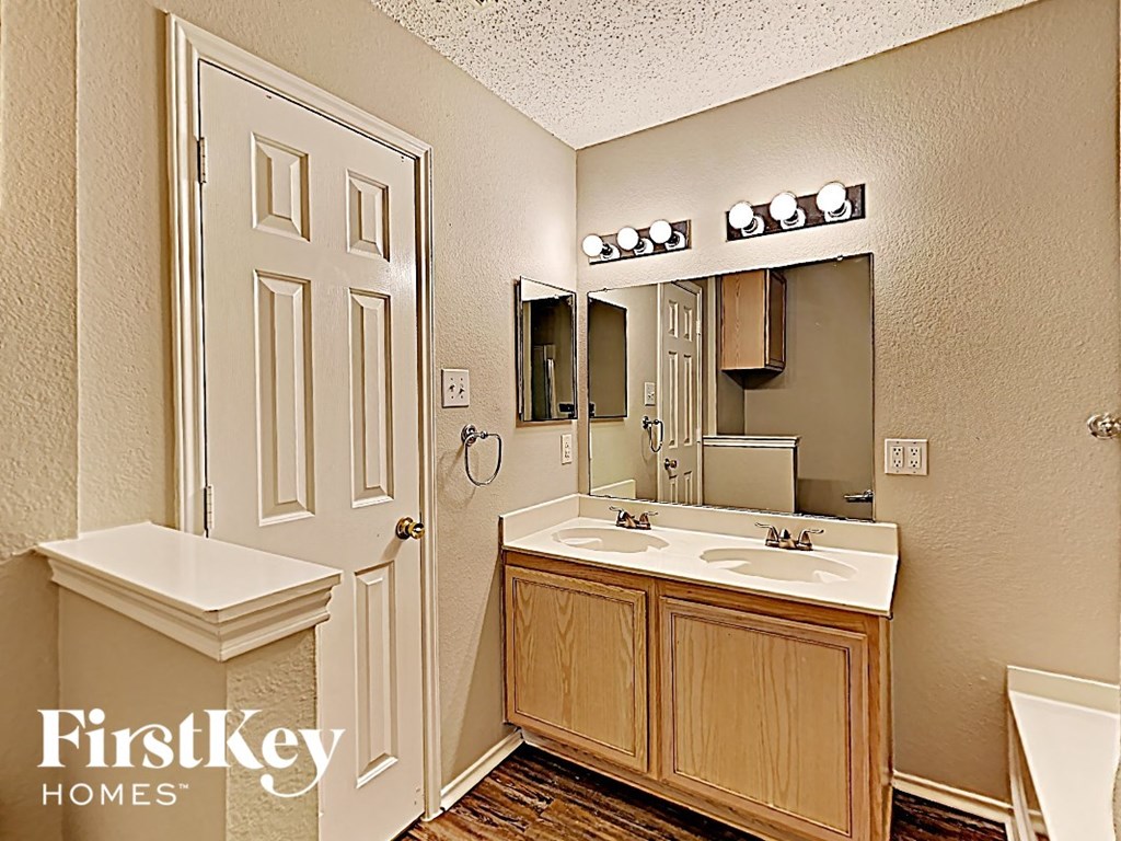 a bathroom with a sink and a toilet and a mirror