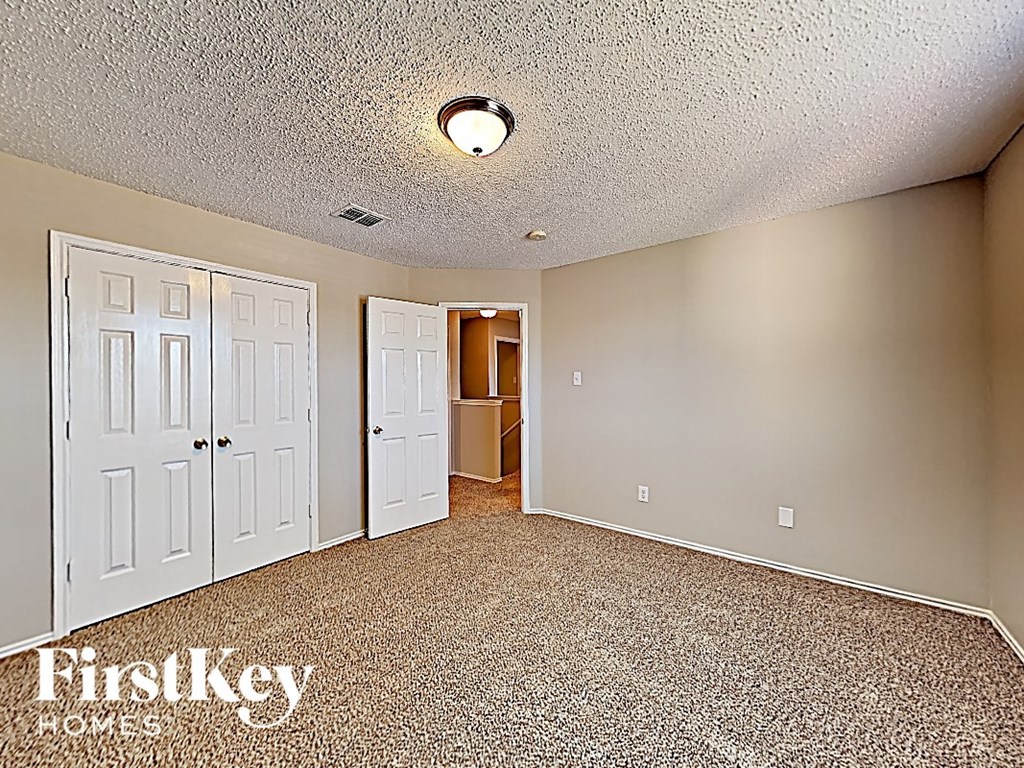the living room of an empty house with white doors