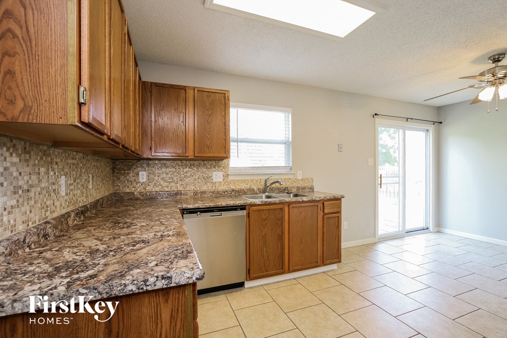 a kitchen with wooden cabinets and a counter top and a sink