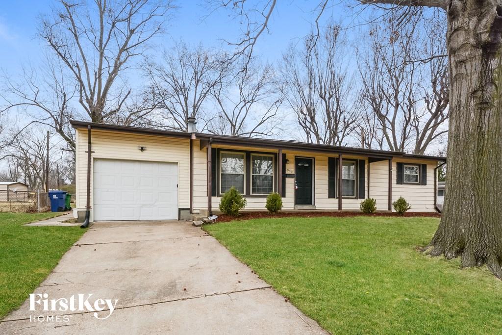 a yellow and with a white garage door