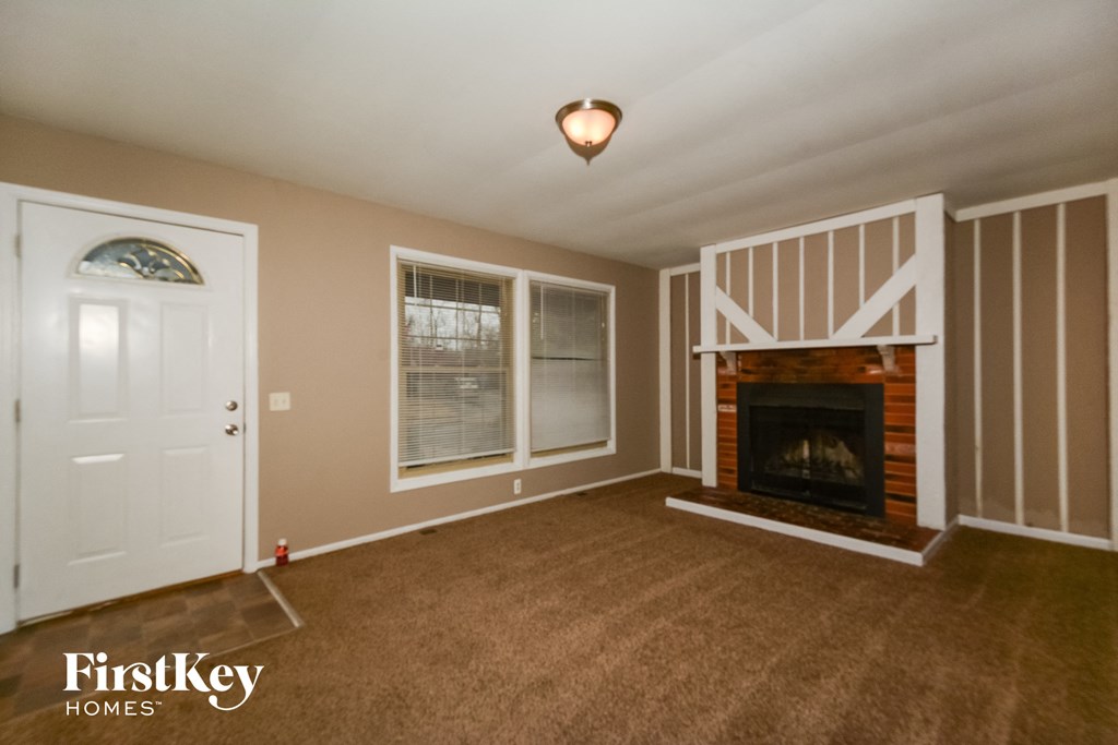 a living room with a fireplace and a white door