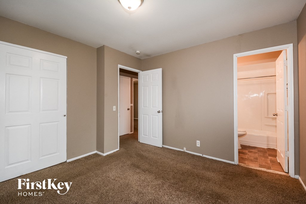 a bedroom with two closets and a door to a bathroom