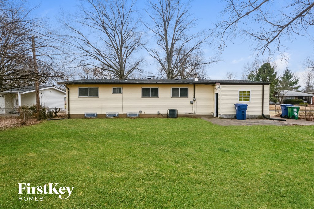 a white house with a yard in front of it