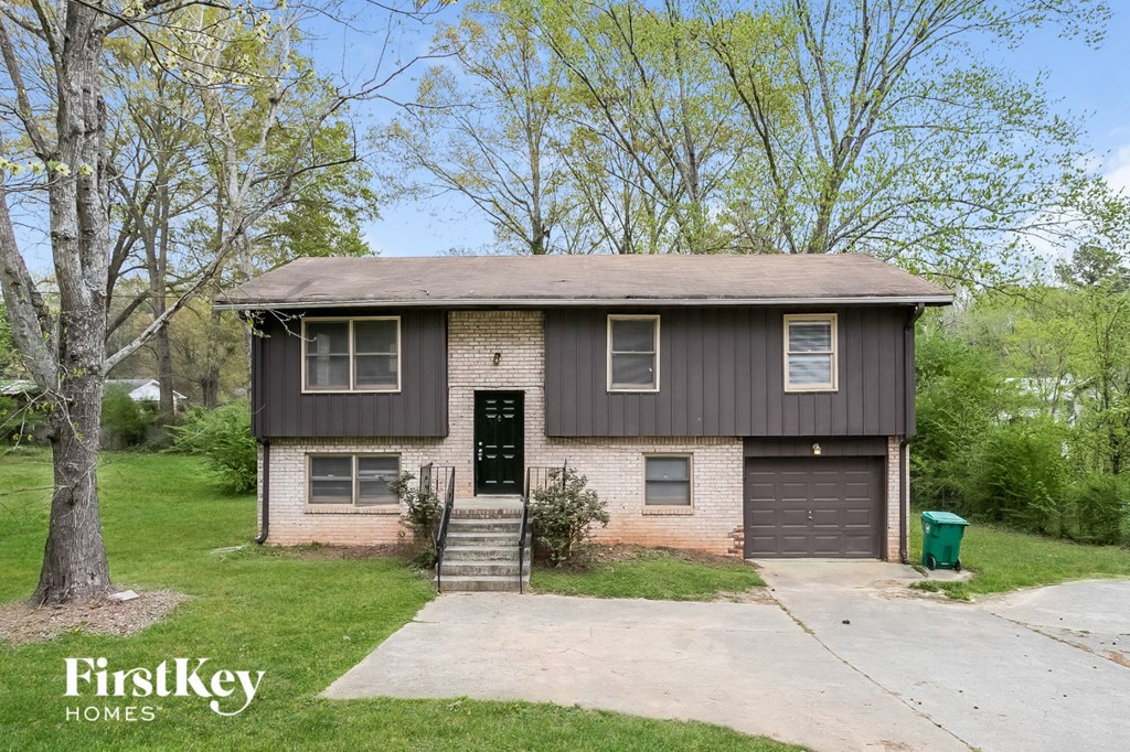 a brown and white brick house with a black door