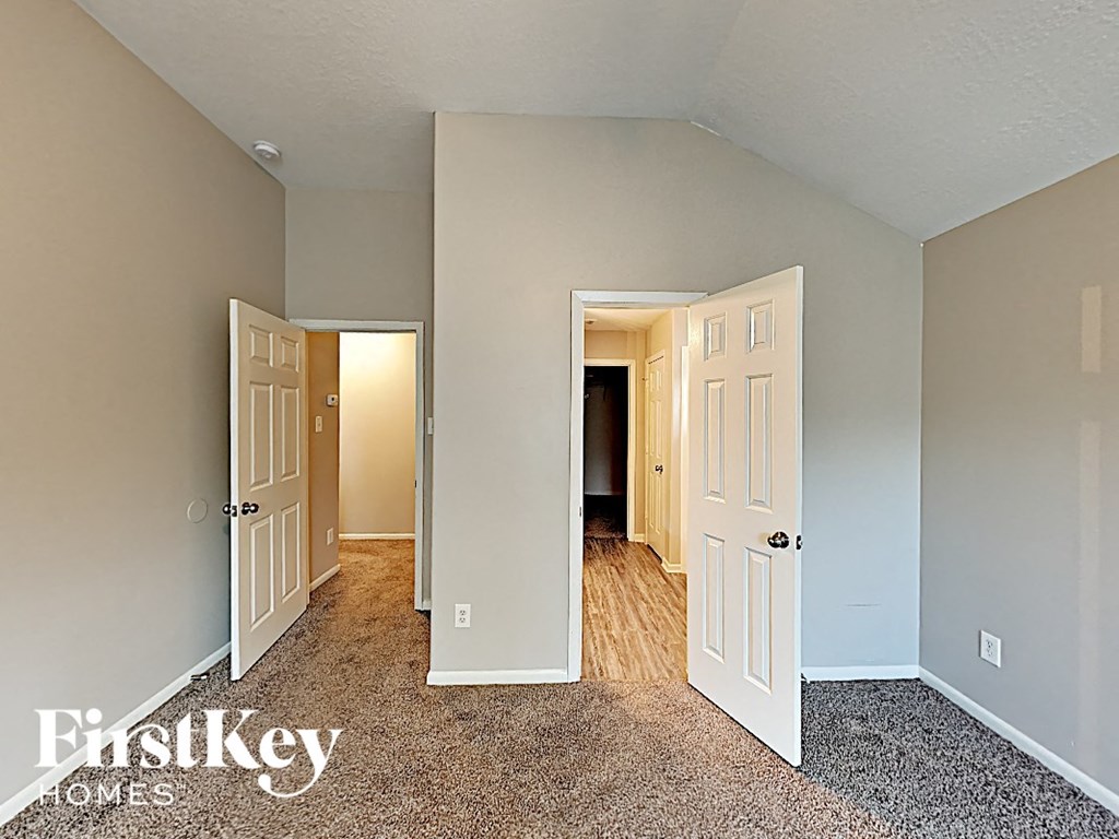 the master bedroom is spacious and opens to the hallway with two doors