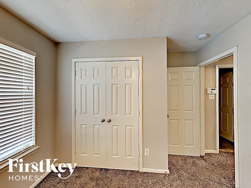 the master bedroom has two closets and a door to the hallway
