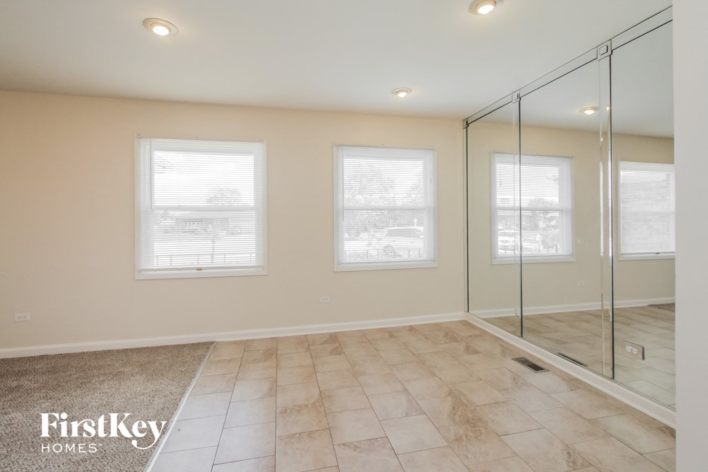 A room with a glass door and two windows.