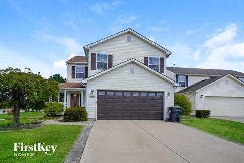 a white house with a brown garage door