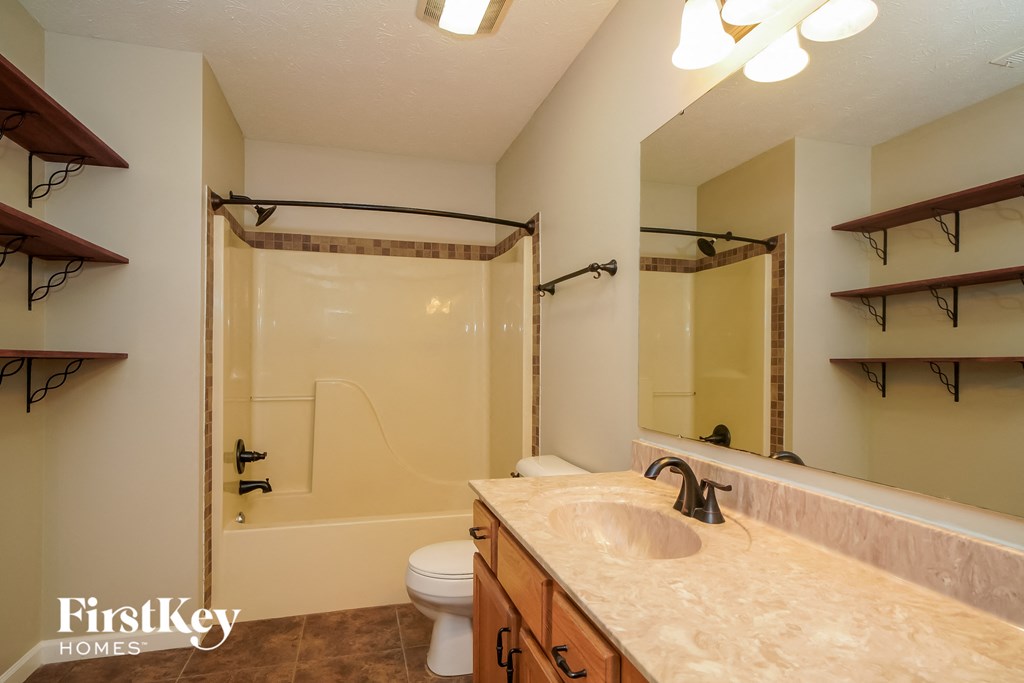 a bathroom with a sink and a shower and a toilet