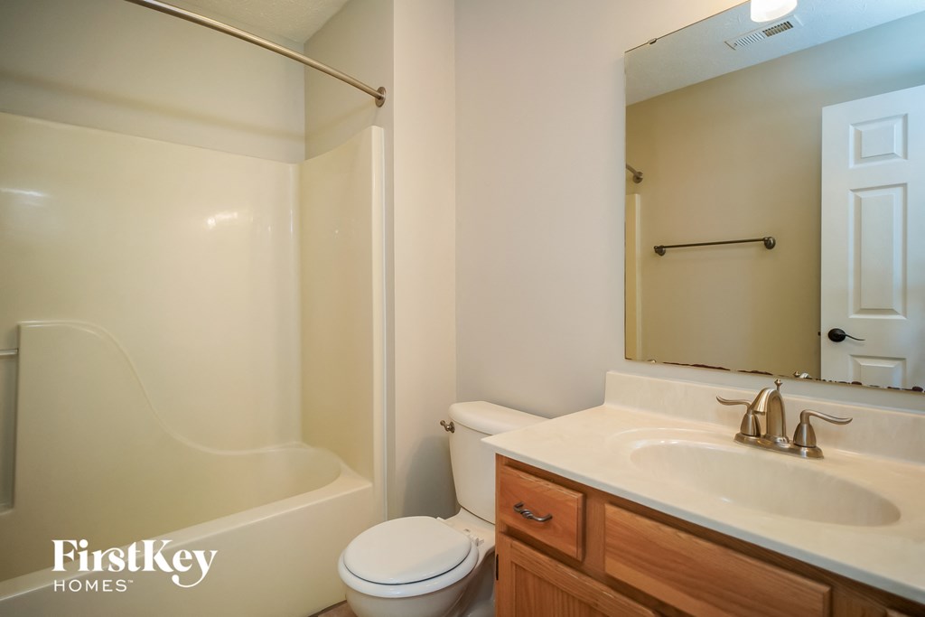 a bathroom with a sink and a toilet and a bath tub