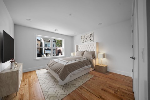 a bedroom with a bed and a window