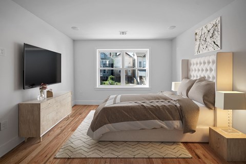 a bedroom with a bed and a tv