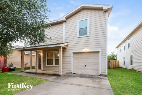 A two-story house with a garage is for sale.