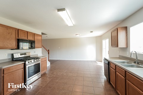 a kitchen with wooden cabinets and a stove and a sink