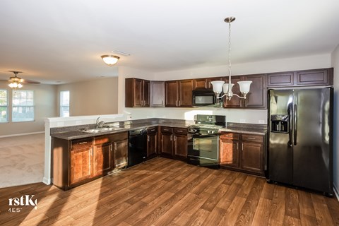 a kitchen with wooden cabinets and stainless steel appliances