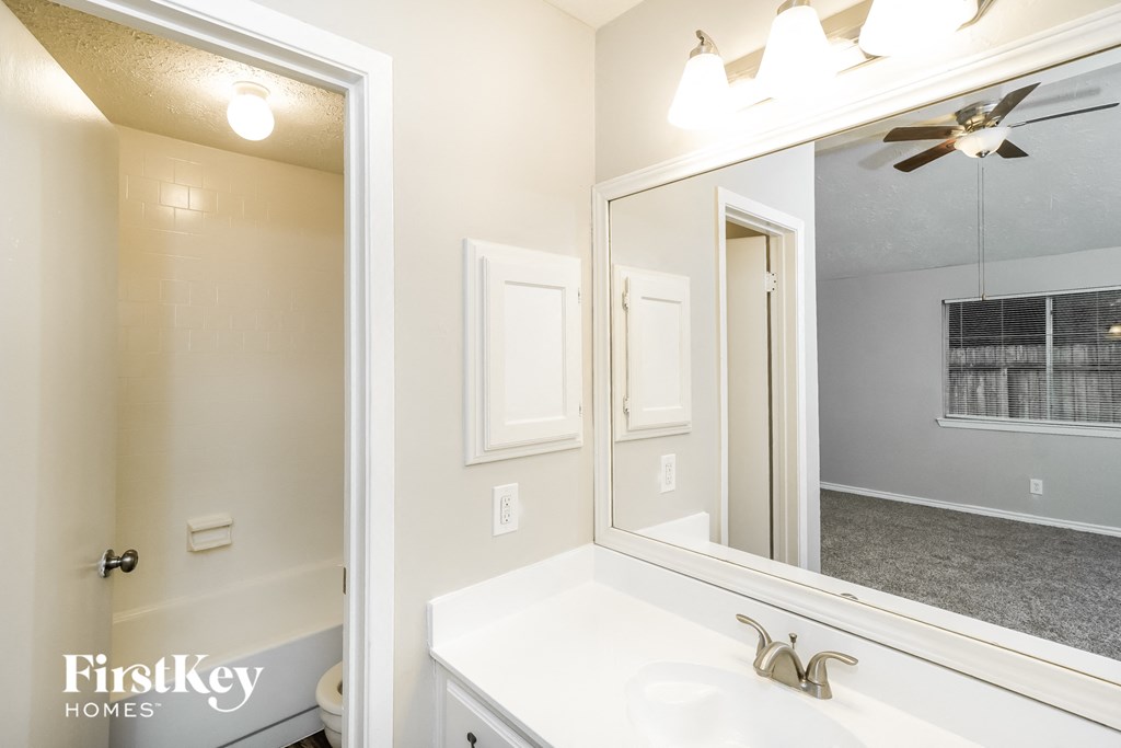a bathroom with a large mirror and a sink