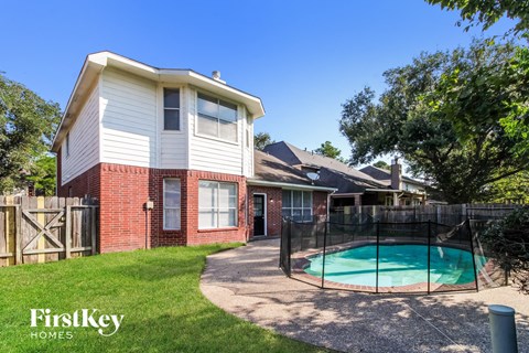 a backyard with a pool and a house