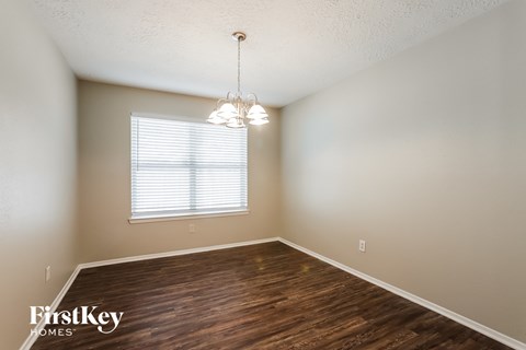 the spacious dining room with wood flooring and a window