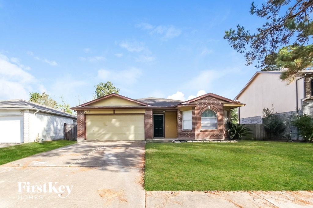 a house with a driveway and a lawn